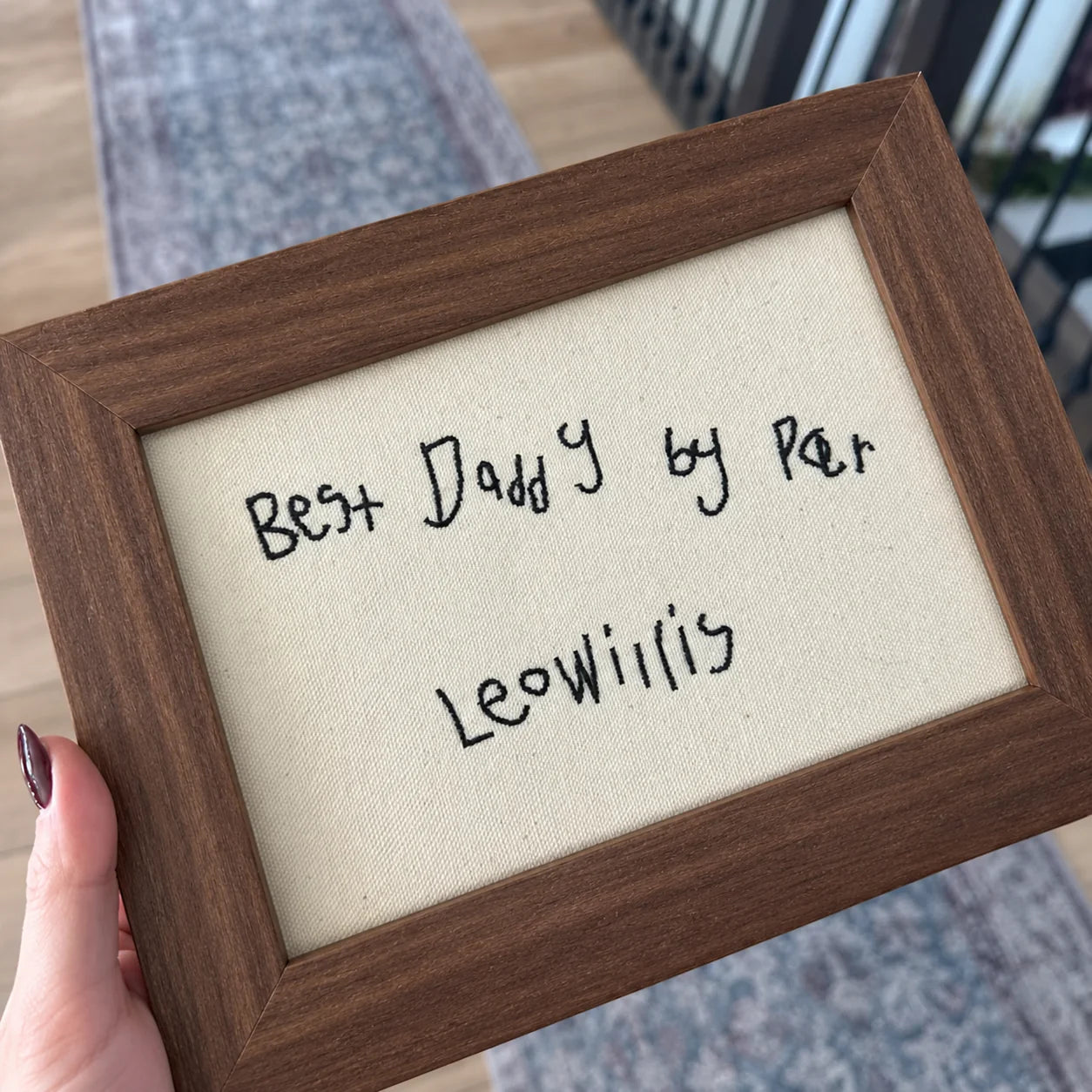 A personal handwritten note embroidered in black thread