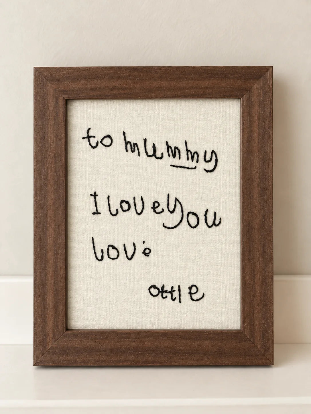 A handwritten note to Mummy embroidered in black thread